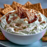 Velvety cheesecake dip served chilled with crunchy graham crackers for easy dipping.  