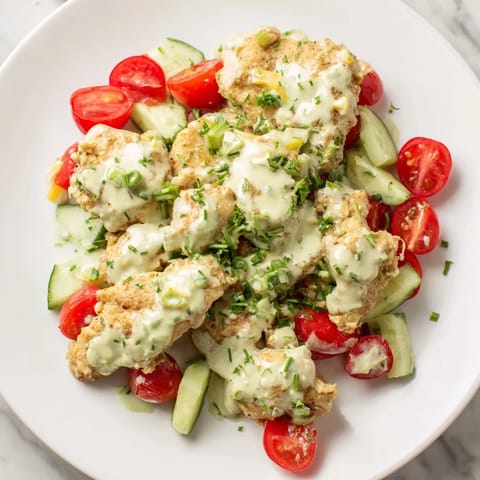 Sliced cherry tomatoes, cucumber, and crisp romaine lettuce topped with tender chicken and rich avocado ranch for a refreshing bite.