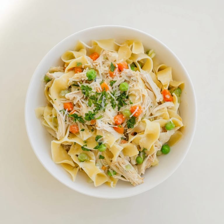 Spring Chicken Noodle Skillet features a comforting mix of carrots, peas, and egg noodles in a light, creamy sauce, ready to serve.