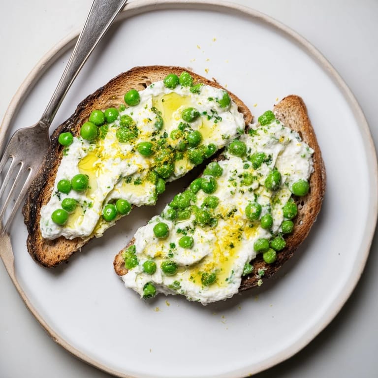 Crunchy toasted sourdough spread with minty pea ricotta and lemon, finished with a drizzle of olive oil.