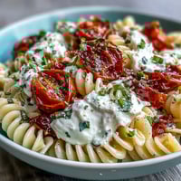 Caprese Pasta with Burrata: Fresh cherry tomatoes, basil, and creamy burrata over al dente pasta, drizzled with olive oil.  