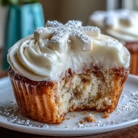 Tender communion cupcakes with fluffy white buttercream and delicate fondant crosses.